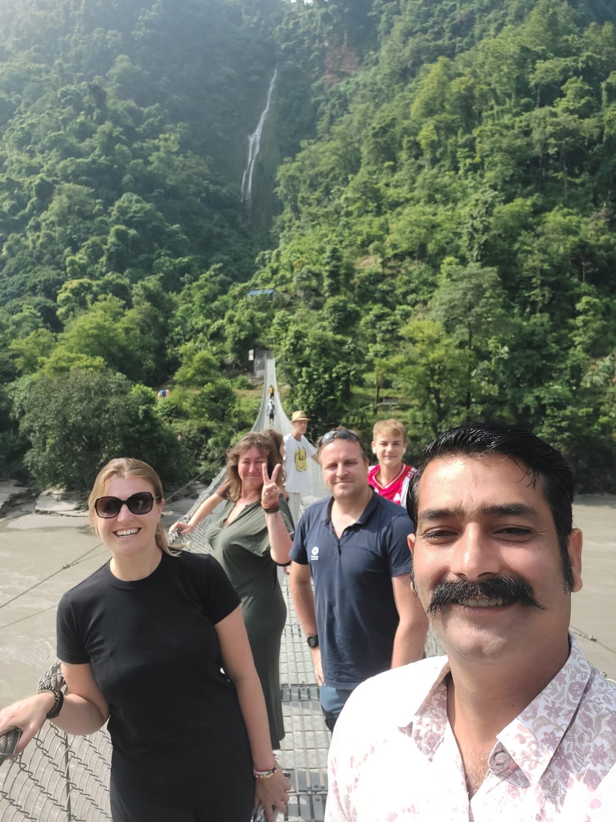 Scenic bridge crossing in lush green landscape in Nepal