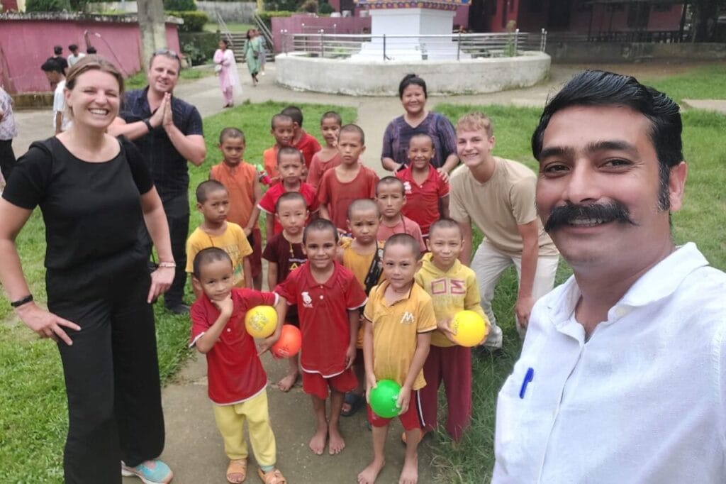 Travelers spending time with children at an orphanage in Nepal