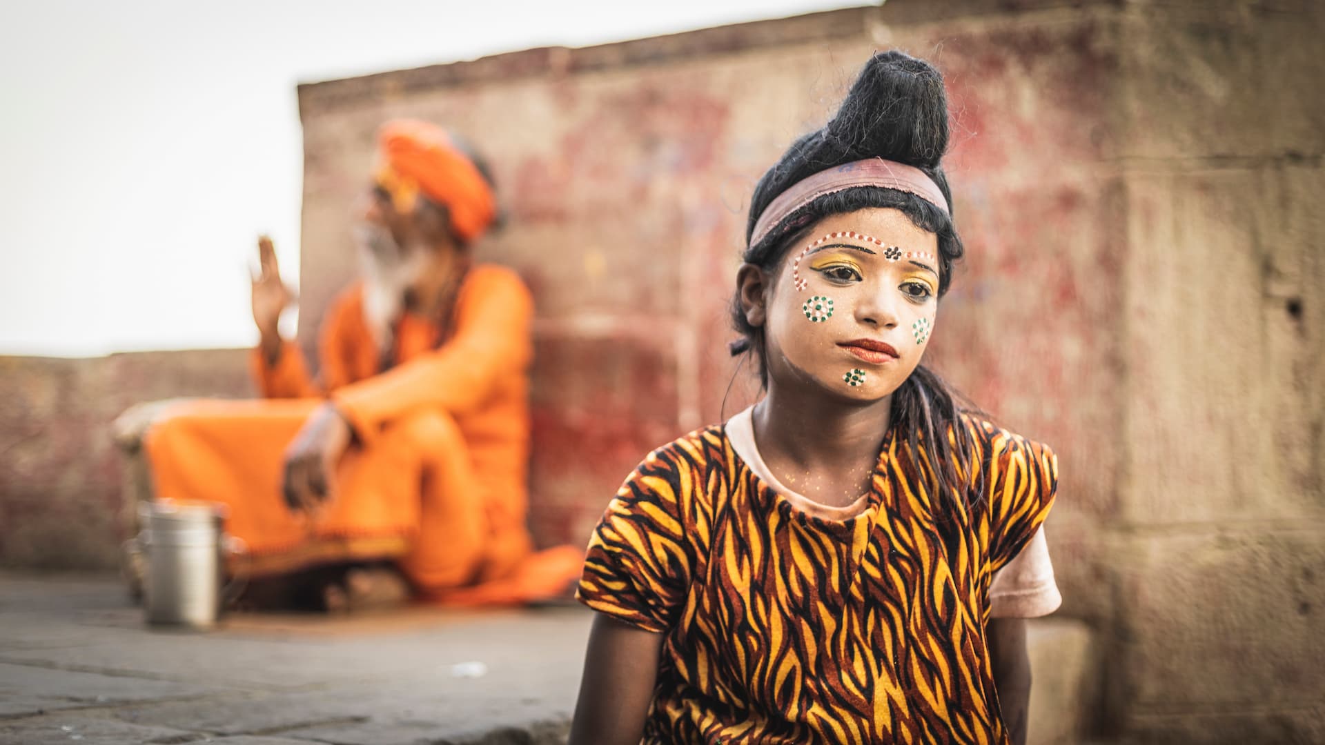 Street scene with children in face paint by the Ganges River in Varanasi