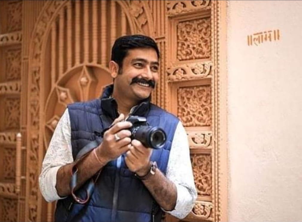 Kapil with his camera in a doorway